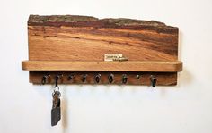 a wooden coat rack with keys hanging from it