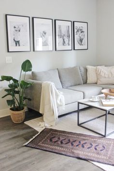 a living room filled with furniture and pictures on the wall