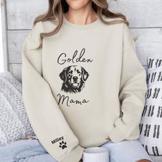 a woman sitting on a bed wearing a sweatshirt that says golden mama