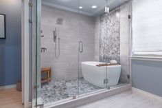 a large bathroom with a walk in shower next to a bathtub and sink area