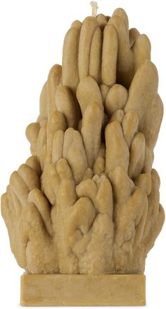 a sculpture of several hands holding each other on a wooden base with a white background