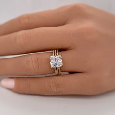 a woman's hand with a ring on it and a diamond in the middle