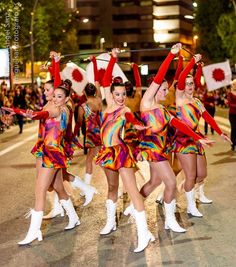 a group of people that are standing in the street with some kind of costume on