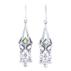 Exude elegance in flashes of green with these exquisite dangle earrings from India's Alok Jain. Sterling silver architectural bezels house two faceted peridot gems. Tiny globes dance beneath creating movement as the wearer moves. Green Nickel Free Dangle Chandelier Earrings, Green Nickel-free Dangle Chandelier Earrings, Green Chandelier Earrings For Anniversary, Green Faceted Sterling Silver Earrings, Green Filigree Dangle Jewelry, Green Dangle Chandelier Earrings For Anniversary, Green Dangle Chandelier Earrings For Formal Events, Green Dangle Chandelier Earrings For Formal Occasions, Green Sterling Silver Dangle Earrings