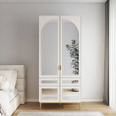 a bedroom with a white bed and mirrored cabinet next to a plant on the wall