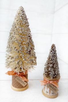 two small christmas trees sitting on top of each other