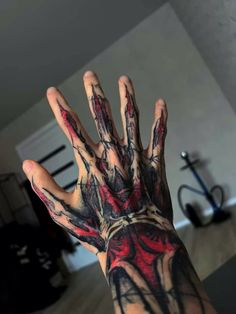 a person's hand covered in black and red ink