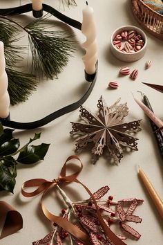 various crafting supplies are laid out on a table with ribbons, scissors and other items