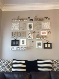 a living room wall filled with lots of pictures and frames on it's wall