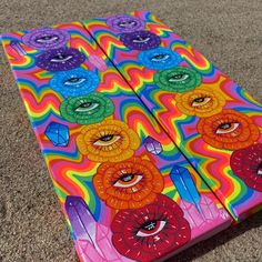 an art piece is laying on the ground in front of a carpeted floor with colorful designs