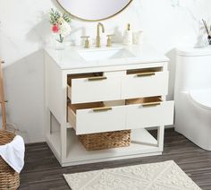 a bathroom vanity with two drawers and a mirror on the wall next to a toilet