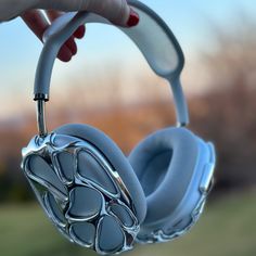 a close up of a person's hand holding headphones with animal paw prints