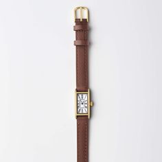 Reminiscent of a tied ribbon, the streamlined silhouettes of yesteryear gave inspiration for this romantic double tour leather strap. This one's in the perfect nut-brown neutral—out go-to when black feels too formal. Small Gold Watch, Gold Watch For Women, Women March, Minimal Watch, Tied Ribbon, Small Watch, Brown Watches, Vintage Timepiece, Watches Women Leather