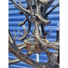 a chandelier made out of wood and metal with antlers hanging from it