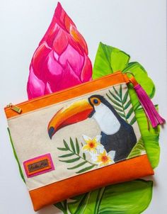 an orange and pink purse with a toucan on it