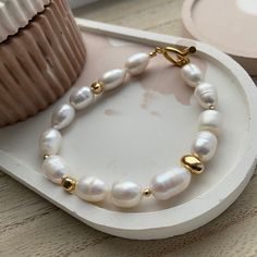 Handcrafted with an artisan's passion, with a unique design, this bracelet exudes an aura of sophistication that defies time. The pearls, gracefully strung together, encircle your wrist like a celestial dance, embracing you in an aura of opulence and grace. Cherish and Care: Like a precious work of art, these pearls demand tender care. Keep them away from harsh elements, allowing them to shine brightly for generations to come. A gentle caress with a soft cloth is all they need to maintain their radiant allure MEASUREMENTS: Choose a length for your pearl bracelet. Measure the length of your wrist with a measuring tape or you can use any thread and after apply the measurements to a regular ruler.  If you have any questions about your size or materials  be free to text me a message. Baroque Pearl Bracelets For Wedding, Baroque Pearl Wedding Bracelets, Classic Baroque Pearl Bracelets, Beaded Baroque Pearl Bracelet, Handmade Elegant Pearl White Bracelets, Gold Baroque Pearl Bracelets For Wedding, Elegant Polished Beads Bracelets For Wedding, Handmade Round Bead Bracelets For Anniversary, Handmade Round Beads Bracelet For Anniversary