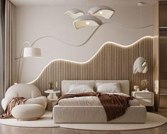 a large bed sitting in the middle of a bedroom next to a wall mounted lamp