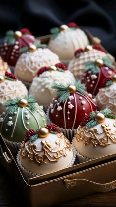 a box filled with assorted decorated chocolates on top of a table