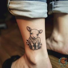 a small sheep tattoo on the ankle with an animal in it's centerpiece