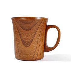 a wooden coffee cup sitting on top of a white table