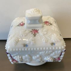 an ornate white box with pink flowers on it