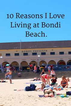 people sitting on the beach in front of a building with text overlay reading 10 reasons i love living at bondi beach