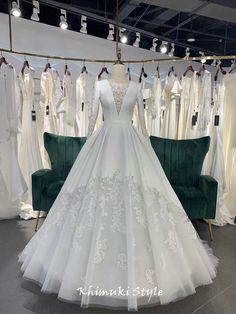 a white wedding dress on display in a store