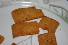 crackers on a white plate sitting on a table