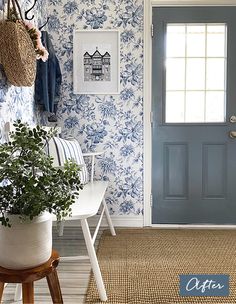 a blue and white entryway with floral wallpaper, potted plant and coat rack