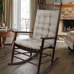 a rocking chair in front of a fireplace