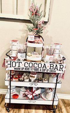 a table topped with lots of desserts and coffee mugs next to a potted plant