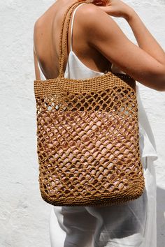 a woman carrying a straw bag on her back