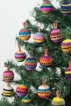 a christmas tree with colorful ornaments hanging from it's branches