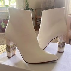 Jasmine White Is A Unique Pointed Ankle Boot With Ornate Mother Of Pearl Heel, Expertly Inlaid With Polished Brass. Part Of Freya Rose's Original Limited-Edition Capsule Collection, Jasmine White Is Crafted In A Soft White Leather, Making It A Beautifully Wearable Day-To-Night Boot, Or A Statement Piece For The Highly Fashionable Bride. The Perfectly Proportioned Silhouette Follows The Natural Curves Of The Foot, Ensuring They Are The Most Comfortable Designer Shoes. Evening White Block Heel Boots, White Block Heel Boots For Evening, Modern White Ankle Boot Heels, Luxury White Party Boots, White Evening Boots With Sculpted Heel, Luxury White Heels With Stacked Heel, Luxury White Stacked Heel Heels, White Party Boots With Stacked Heel, White Stacked Heel Boots For Party