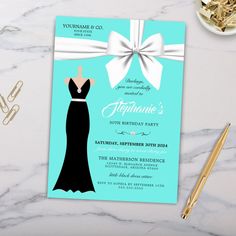 a blue and white birthday party card with a dress on it, next to some gold scissors