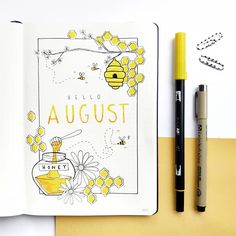 an open notebook with the words hello august written on it next to a pen and some flowers