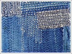 an image of blue fabric with white stitchs