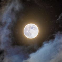 the full moon is seen through clouds in this artistic photo taken from earth's orbit