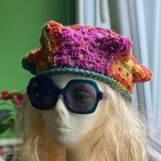 a wig wearing sunglasses and a crocheted hat