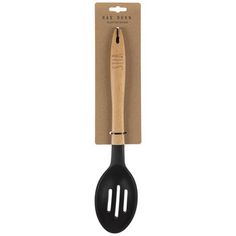 a black spatula with wooden handle on top of a cardboard package and a white background