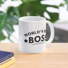 a white coffee mug with the words world's best boss on it sitting on a table