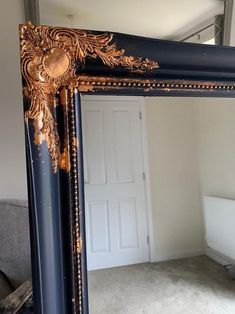 an ornate mirror is shown in the middle of a room