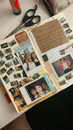 an open scrapbook with pictures and photos on the pages is sitting on a desk next to a pair of scissors