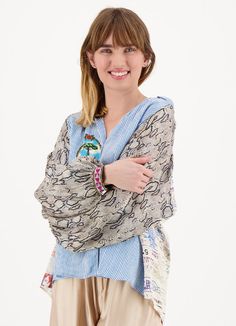 Flowy, long-sleeve button-down top featuring our Snake Charmer print with a collar and slim cuffs. The shirt's body showcases blue stripes with a tree graphic on one side and a flamingo in a heart on the other, accented by the word “Believe” atop the heart. The sleeves display a gray snakeskin print, while the collar and cuffs are adorned with a small geometric pattern. The back is decorated with vintage stamps and a palm tree, accompanied by the phrase “Greetings from FLORIDA”. For a coordinate Summer Cotton Blouse With Striped Sleeves, Spring Blue Shirt With Striped Cuffs, Blue Shirt With Striped Cuffs For Spring, Relaxed Fit Long Sleeve Tops With Striped Cuffs, Long Sleeve Tops With Striped Cuffs And Relaxed Fit, Spring Cotton Blouse With Striped Sleeves, Blue Long Sleeve Tops With Striped Cuffs, Summer Long Sleeve Tops With Striped Cuffs, Summer Tops With Striped Cuffs And Long Sleeves