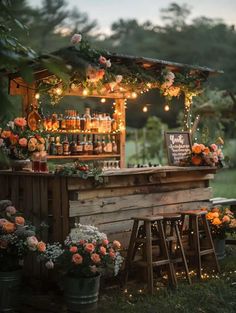 an outdoor bar decorated with flowers and lights