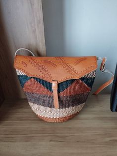 "Brown and black sisal tote bag with leather flap DIMENSIONS Bottom width: 10\" Top width: 14\" Depth: 10\" Straps: 15\" SHIPPING All orders ship via DHL Express (3-5) days delivery time." Casual Handwoven Leather Bag, Woven Leather Bags In Natural Color, Leather Woven Crochet Bag For Everyday, Woven Leather Crochet Bag For Everyday Use, Leather Bucket Straw Bag For Market, Handwoven Top Handle Satchel, Brown Saddle Tote Bag For Errands, Brown Tote Saddle Bag For Errands, Handwoven Leather Bucket Bag For Daily Use