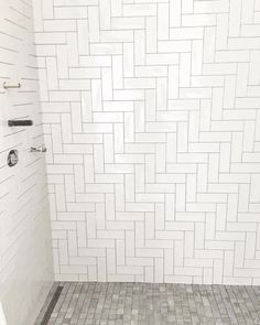 a white tiled shower stall in a bathroom