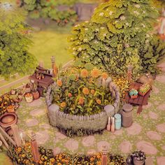 a miniature garden is shown with flowers and potted plants on the ground in front of it