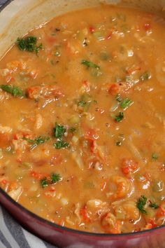 a red pot filled with soup on top of a table