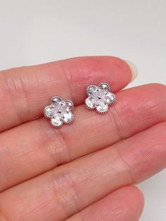 925 Sterling Silver Cz Flower Stud Earrings - Metal: 925 Sterling Silver (Finish: Rhodium Plated) - Stone: Clear Cubic Zirconia, Pear Shaped, Prong - Shape: Flower - Dimension: 9mm(0.35 in), Thickness 1.5mm (Please note that the flower is SMALL.) - Closure: Post at Center, Push Back - Color: Silver Sterling Silver Flower Earrings For Anniversary And Mother's Day, Diamond White Flower Earrings For Anniversary, Classic Flower-shaped Cubic Zirconia Earrings, Classic Diamond White Flower Earrings As Gift, Classic Diamond White Flower Earrings For Gift, Sparkling Flower Earrings For Anniversary, Hypoallergenic Flower-shaped Earrings For Anniversary, Flower Shaped Cubic Zirconia Earrings In Diamond White, Flower-shaped Cubic Zirconia Earrings For Anniversary